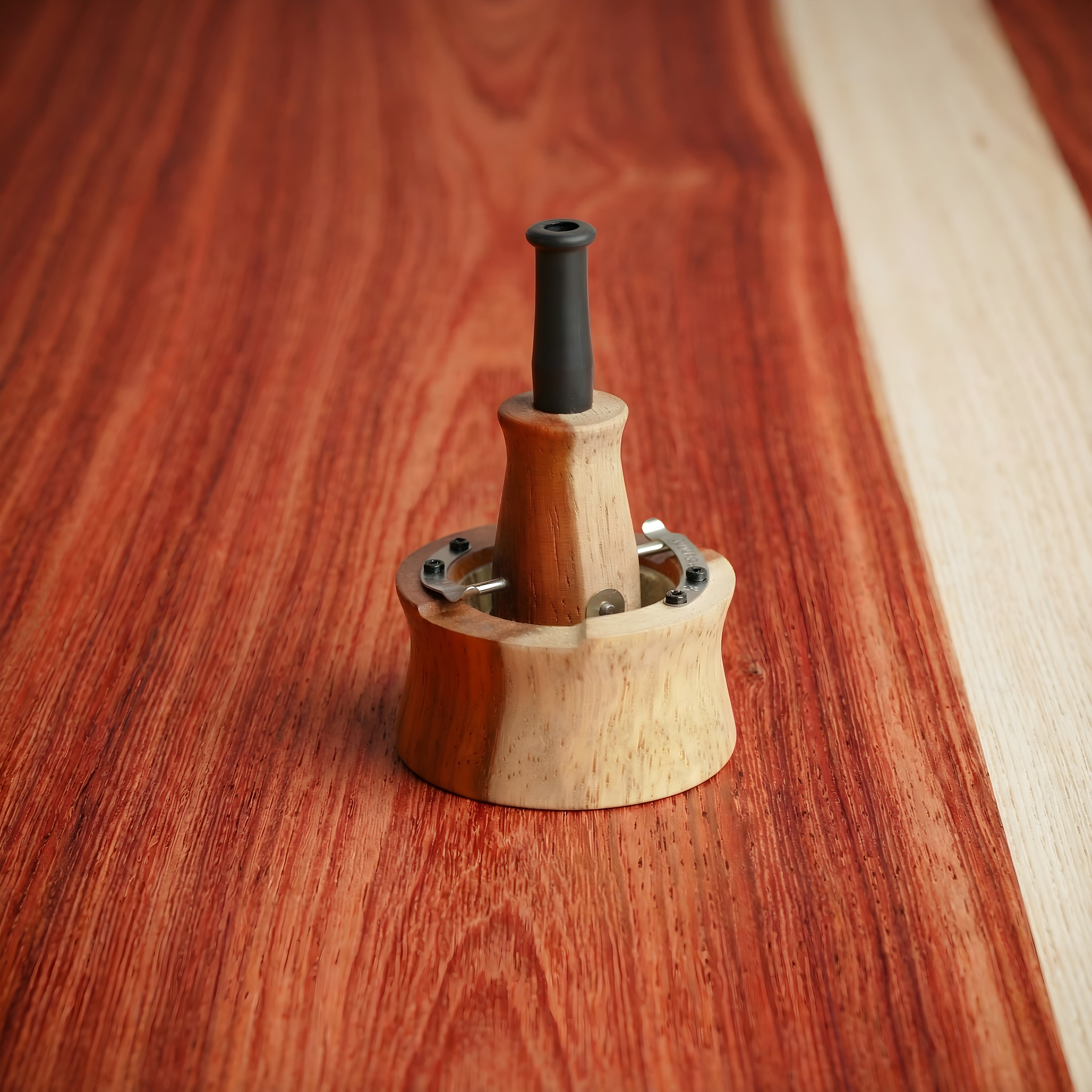 Limited edition Vapman Click vaporizer crafted from two-tone padauk wood, featuring a unique dual wood design and compact structure for precise manual herb use